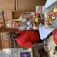 A man and woman standing in front of food.